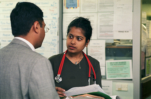 Photo. Two doctors engaged in discussion.